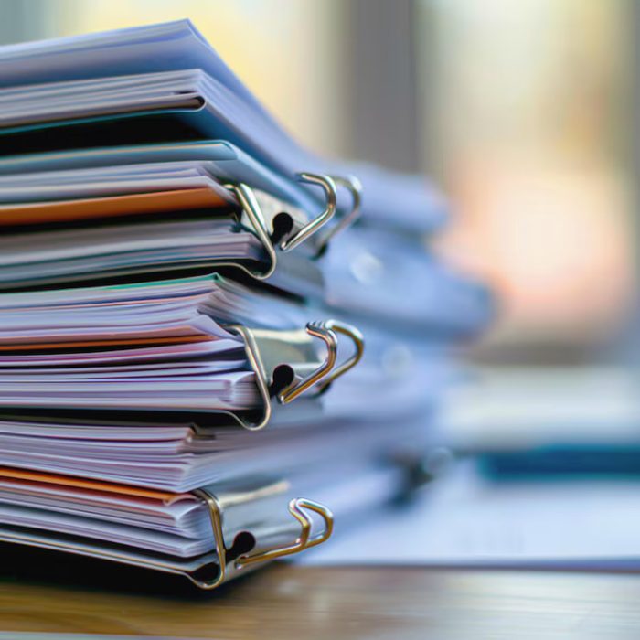 organized-stack-documents-tidy-office-desk-with-soft-sunlight_334364-33771